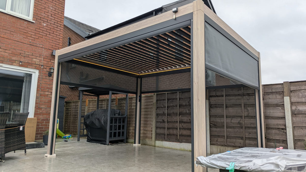 LuxShade™ 3×4m Wood Grain Aluminium Pergola with LEDs, Double-Layered Louvres & 3 Blinds